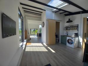 a hallway of a house with a washing machine at The Dutch Barn in Maidstone +14 photos