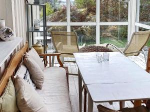 a living room with a white table and chairs at 4 star holiday home in Åskloster in Åskloster +24 photos