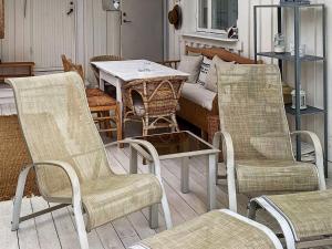 a group of chairs and a table in a living room at 4 star holiday home in Åskloster in Åskloster