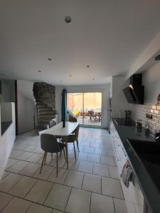 a kitchen and dining room with a table and chairs at Maison de village Olonzac in Olonzac +12 photos