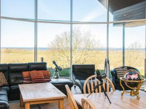 a living room with a couch and chairs and a table at 5 star holiday home in Højslev in Højslev