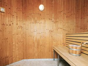a wooden wall with a bucket on a wooden bench at 5 star holiday home in Højslev in Højslev