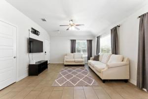 a living room with two couches and a flat screen tv at Luxury Home Mins to JPS & Medical City Fort Worth in Fort Worth