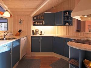 a kitchen with blue cabinets and a sink at 6 person holiday home in Frederiksværk-By Traum in Frederiksværk