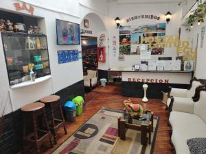 a living room with a couch and a table at Hostal Latitud Ecuem in Quito