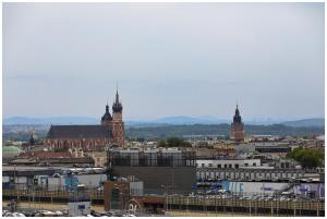 a view of a city with two tall clock towers at Jacuzzi Glass-House Central Station in Kraków +142 photos