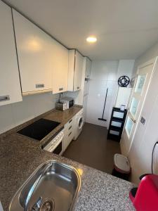 a kitchen with a sink and a counter top at La Manga Beach Club Frontal by Alina365 in La Manga del Mar Menor