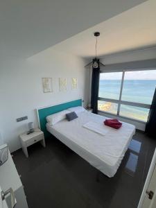 a bedroom with a bed with a view of the ocean at La Manga Beach Club Frontal by Alina365 in La Manga del Mar Menor