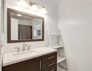 a bathroom with a sink and a mirror at Island Charm, Near Tybee in Savannah +21 photos
