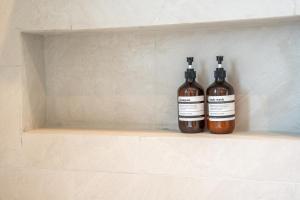 two bottles of alcohol are sitting on a shelf at The Pinnacle Katanoi in Kata Beach