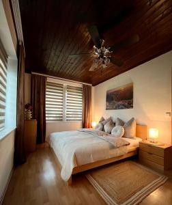 a bedroom with a bed and a ceiling fan at SUP CoTtAgE gArDeN in Sankt Jakob im Rosental +19 photos