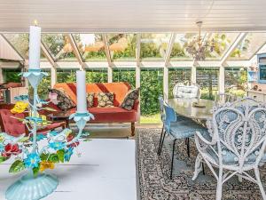 a conservatory with a table and chairs at 4 person holiday home in Thisted in Thisted