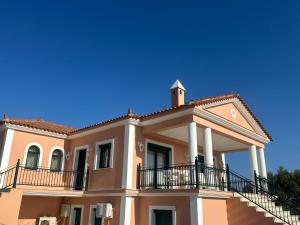 a large house with a balcony on top of it at Villa Zante Estrella in Kalamaki