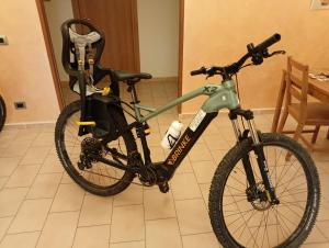 a bike is parked in a room at Hotel Aquila in Scoppito