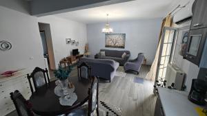 a living room with a table and a couch at Apartment with Mountain View in Kato Loutraki