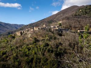 a village on the side of a mountain at Écolieu La Bernarde - Gîte Nature in Dompnac
