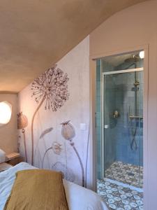 a bedroom with a shower with a flower mural on the wall at Écolieu La Bernarde - Gîte Nature in Dompnac +73 photos
