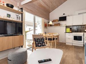 a kitchen and living room with a television and a table at 4 person holiday home in Ærøskøbing in Ærøskøbing