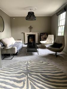 a living room with a bed and a fireplace at Gorgeous Georgian townhouse in Moffat