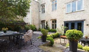 a garden with a table and chairs in front of a building at Gorgeous Georgian townhouse in Moffat