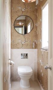 a bathroom with a toilet and a mirror at Gorgeous Georgian townhouse in Moffat