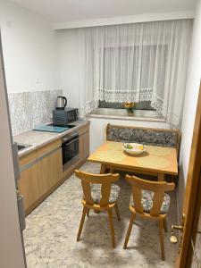 a small kitchen with a table and two chairs at Tina`s Ferienwohnung in Kapfenberg +13 photos