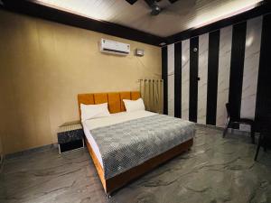 a bedroom with a bed in a room at The Family Palace in Ayodhya +15 photos