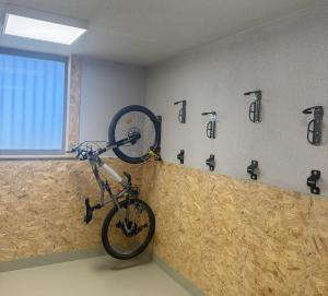 a bike is hanging on a wall in a room at Appartement 6 personnes ARC 1800 in Bourg-Saint-Maurice