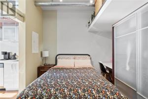 a bedroom with a bed and a desk in a room at one bedroom in Victoria