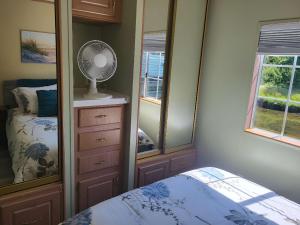 a bedroom with a bed and a dresser with a fan at Cozy, Private Guest House #5 in Blaine