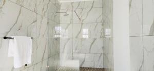 a bathroom with a shower with a glass door at Mthiyane Dam View in Hartbeespoort +49 photos