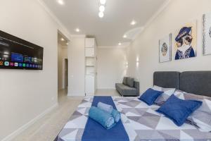 Un dormitorio con una cama grande con almohadas azules. en Dream Stay, en Astana