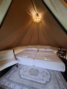 a bedroom with a bed in a tent at Dieng Latar Alam Tambi Syariah in Kejajar