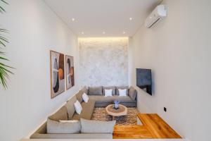 a living room with a couch and a table at Exclusive 4BR Villa with Rooftop, Ricefield Views near Cemagi Beach in Cemagi