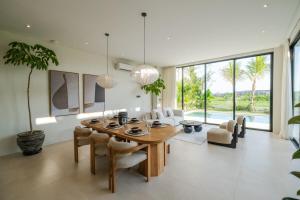 a dining room with a table and chairs at Exclusive 4BR Villa with Rooftop, Ricefield Views near Cemagi Beach in Cemagi