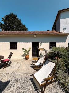 a group of chairs sitting outside of a house at Quinta da Faísca Guesthouse in Vila do Conde