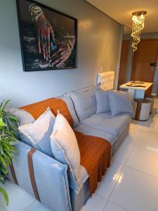 a living room with a couch and a table at Smart Residence Praia in Maceió +43 photos