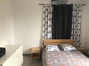 a bedroom with a bed and a black curtain at Grande maison avec jardin a proximité centre ville in Laval