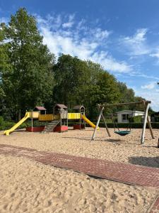 a playground with several slides and swings at Recreatie Chalet in Dordrecht