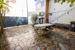 a table and chairs sitting on a stone patio at Duplex avec extérieur, 30 min de Paris et Disney in Saint-Maur-des-Fossés