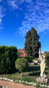 a statue in the middle of a park with trees at Airport Rooms - Bari in Bari