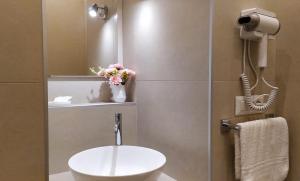 a bathroom with a white sink and a mirror at Perca39 Casa nel cuore di Napoli, zona Sanità in Naples