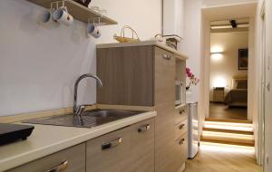 a kitchen with a sink and a counter top at Perca39 Casa nel cuore di Napoli, zona Sanità in Naples
