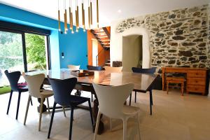 a dining room with a wooden table and chairs at VAUJANYLOCATIONS - Sert et Sagne 2 in Vaujany