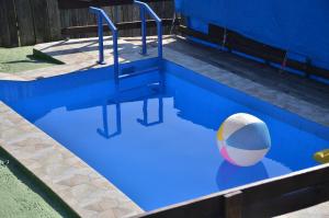 a swimming pool with a beach ball in it at Seosko domacinstvo Radovanovic in Bajina Bašta