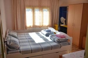 a bedroom with a bed with two pillows on it at Seosko domacinstvo Radovanovic in Bajina Bašta +50 photos