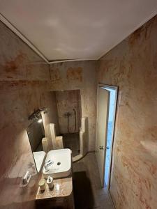 a bathroom with a sink and a shower at BAHIA Guest House in Hydra
