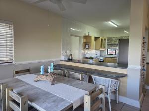 a kitchen with a table with a cat sitting on it at 13 Seaverge in Port Edward +21 photos