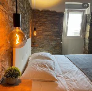 a bedroom with a large bed and a window at CASA DO XASTRE in Arnego +11 photos