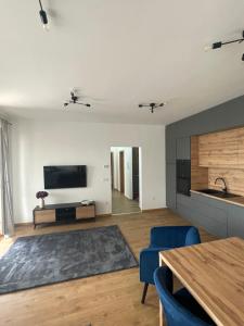 a living room with a television and a table at Riverside Apartment Szeged in Szeged